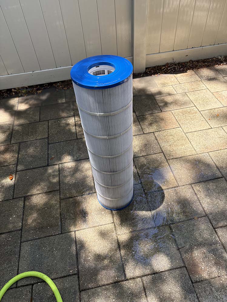 Cleaned pool filter cartridge on a patio after service in St. Petersburg FL